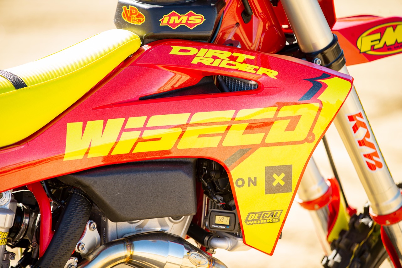 Close up of red and yellow bike on right shroud and Wiseco logo visible
